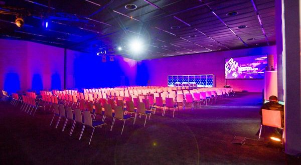 A conference hall at MCK under coloured stage lighting